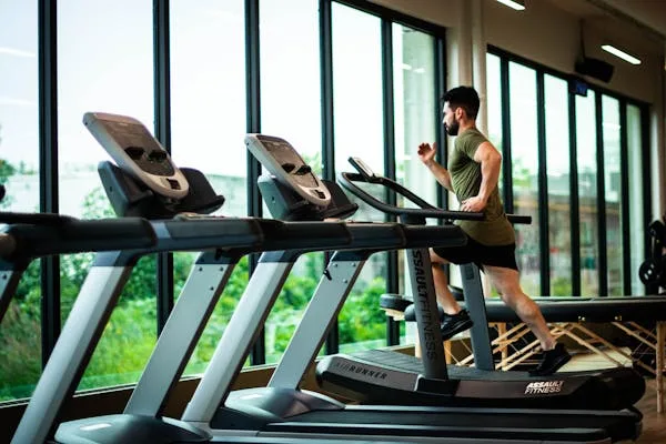 a boy in gym on a treadmill for advanced health and wellness