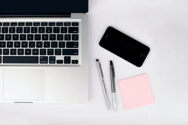 Laptop on the table with notes and mobile